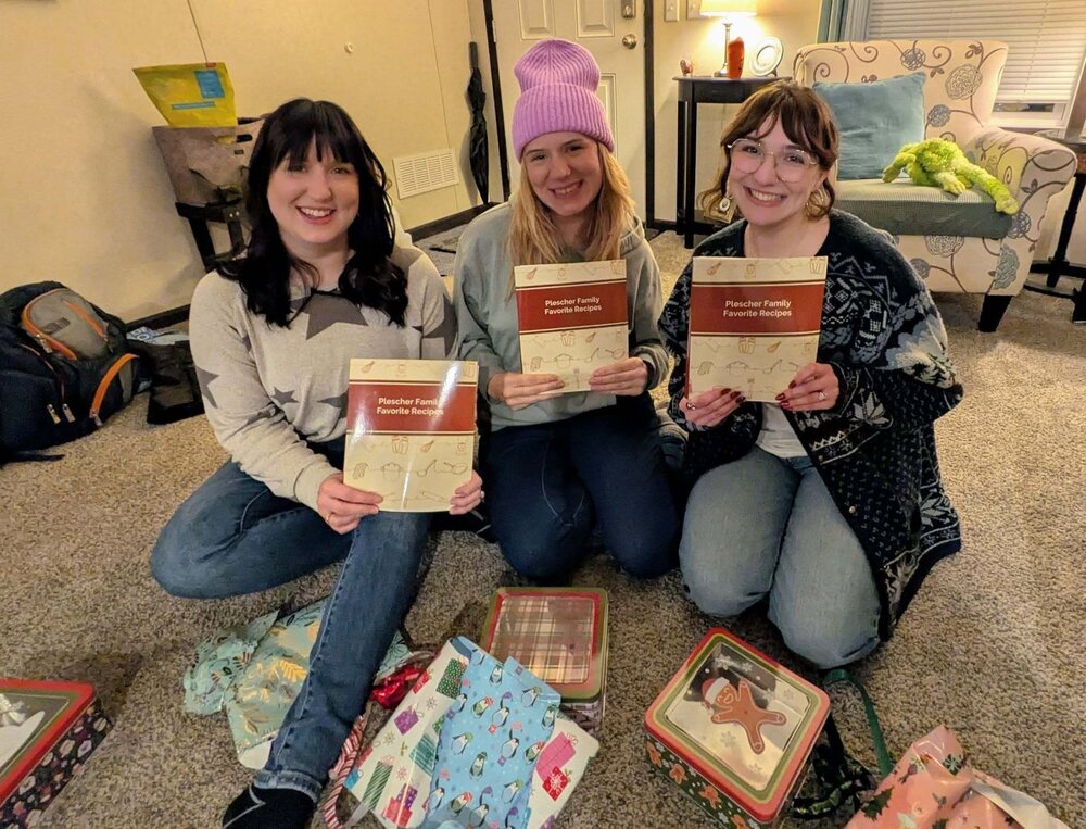 Sisters with their family cookbook